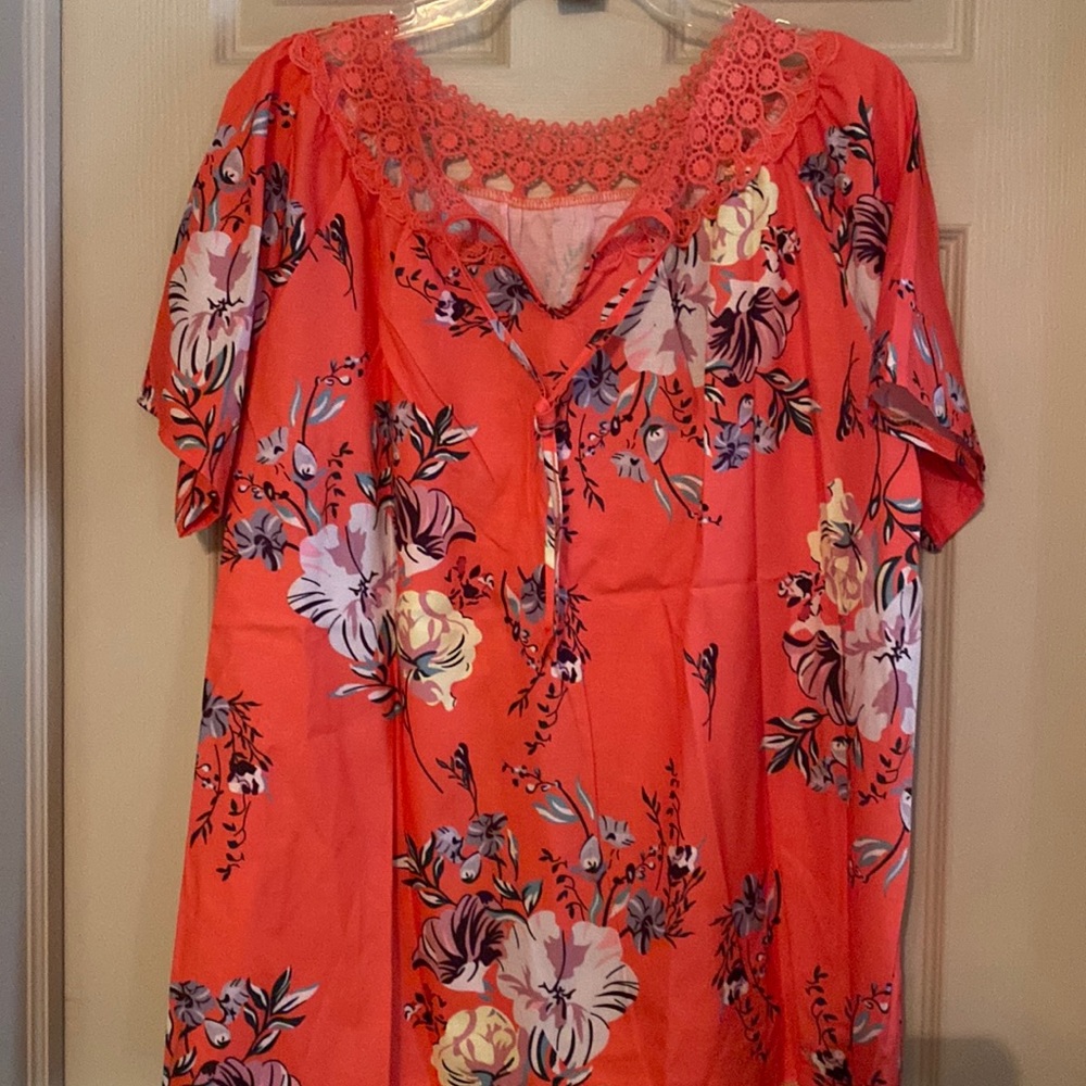 Orange top with lacey neckline  and tie in the front